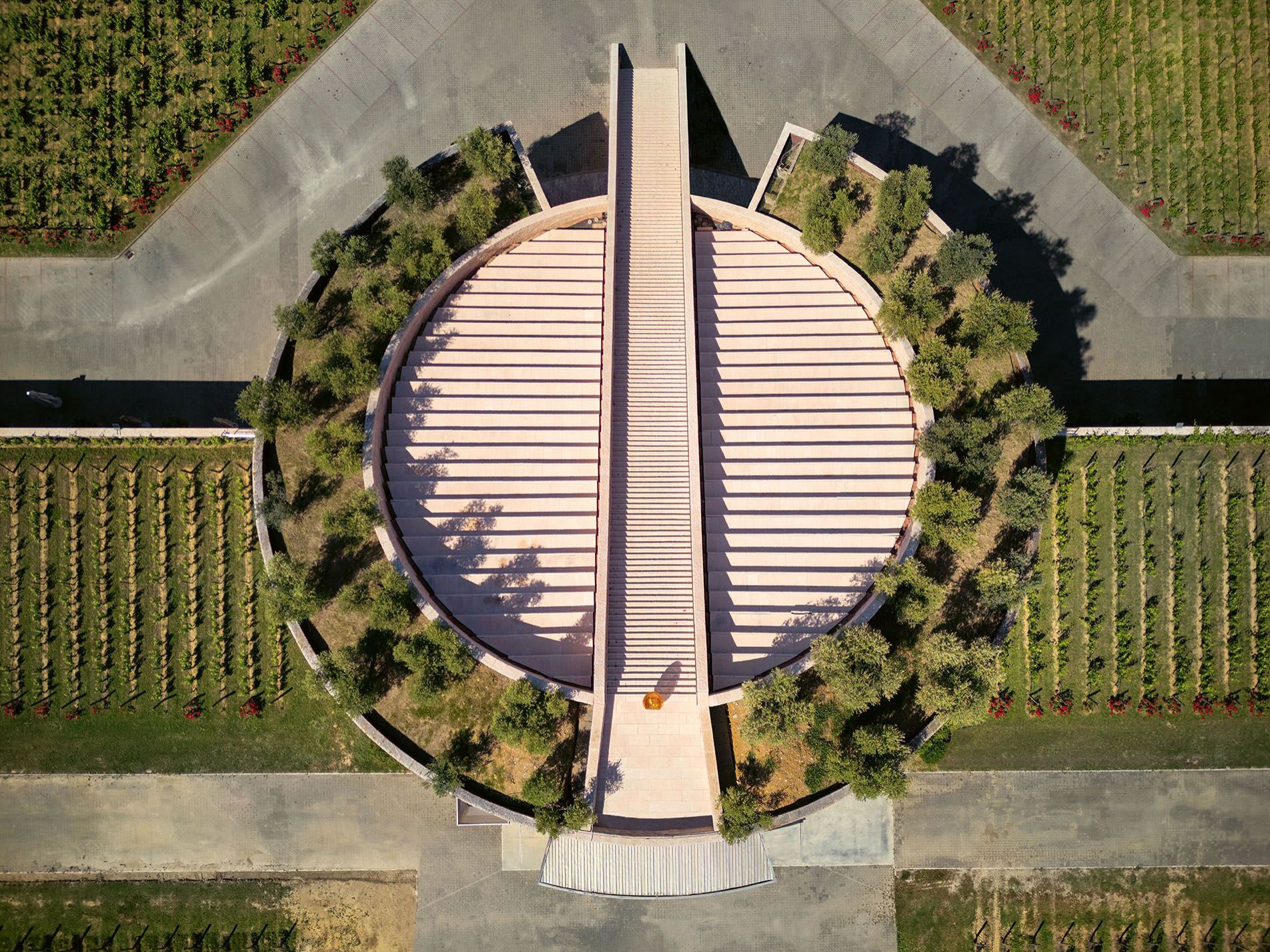  Petra Winery. The sloping roof of the sectioned cylinder is dotted with hanging gardens and a scenic staircase creates a groove down the axis. 