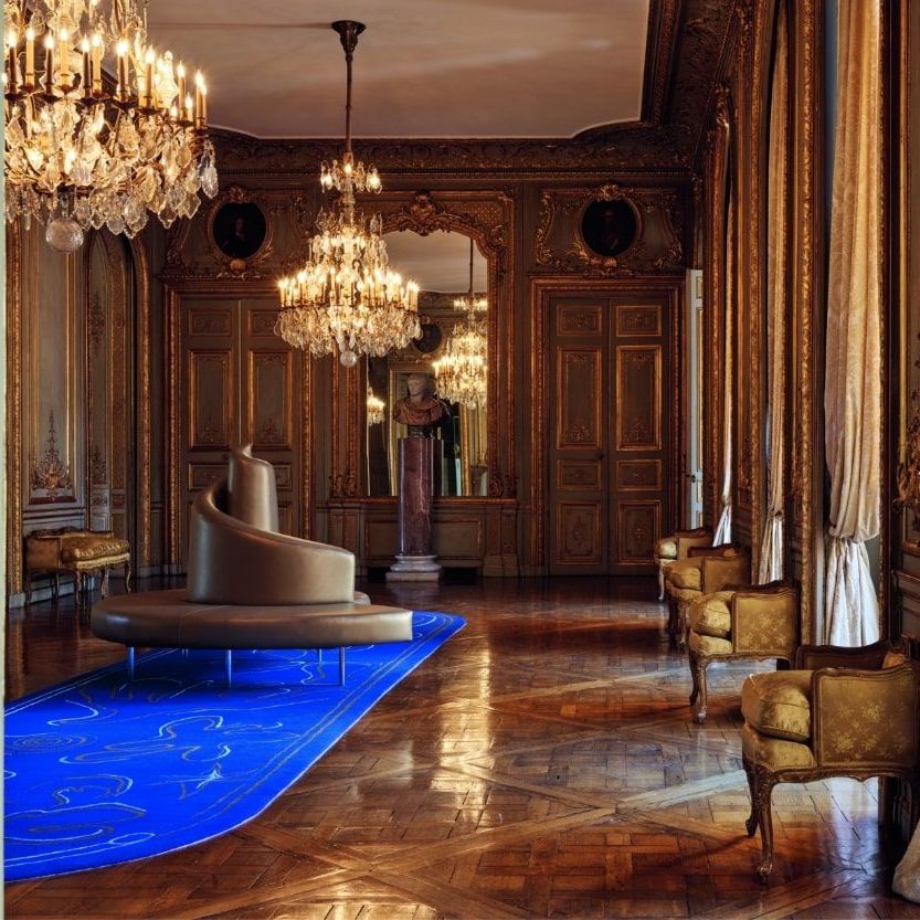  Tatlin in the gold leather version in the large Salon of Globes, on a carpet designed by Daniel Roseberry (Maison Schiaparelli). 