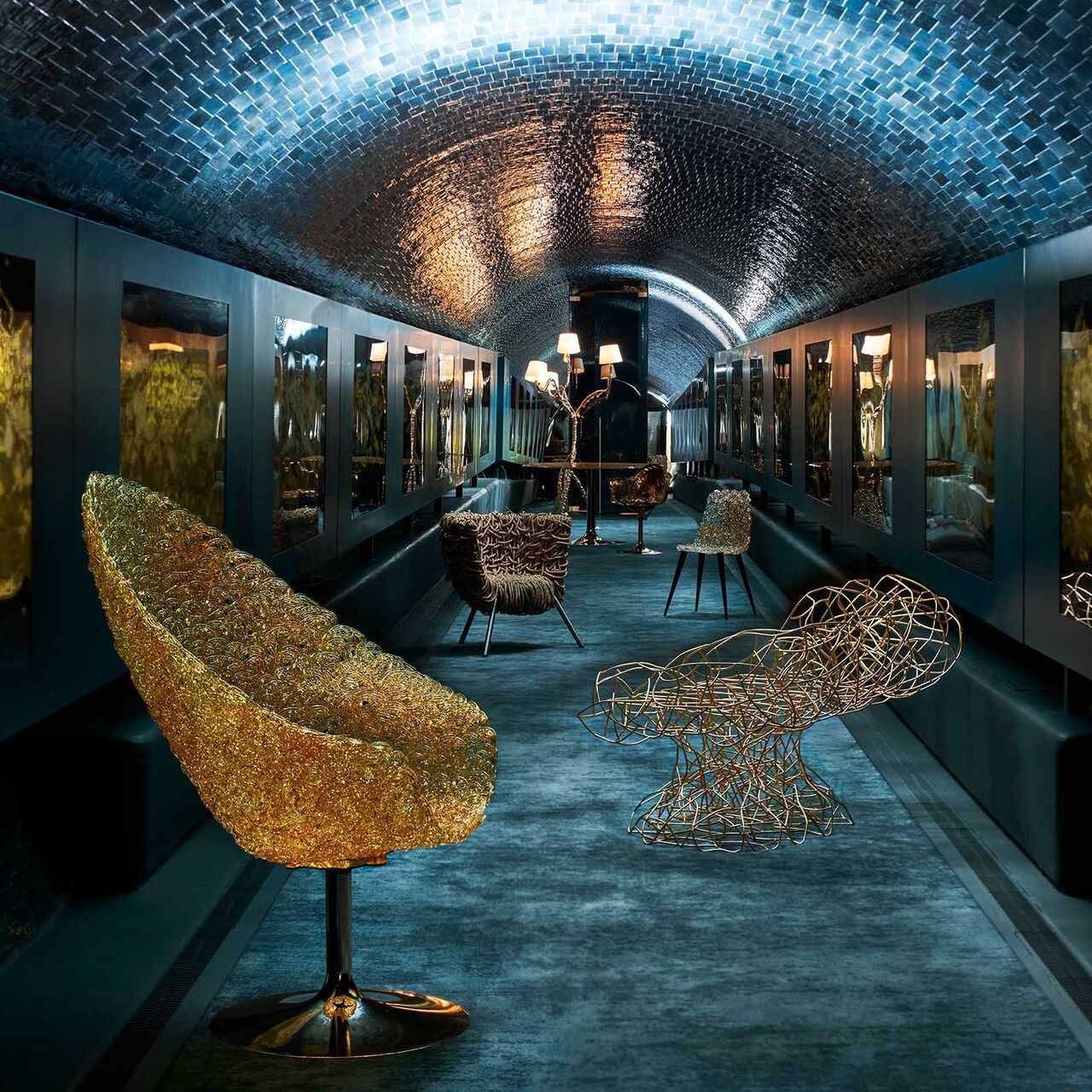  The Edra models inside the Rifugio Digitale in Florence. In a special setting, Margherita, Corallo, Vermelha, Gina, Ella, Egeo, Ines in shades of gold, amplify the expressive power of Fabrizio Plessi’s ORO work, the first exhibition of the Crypto Art gallery 