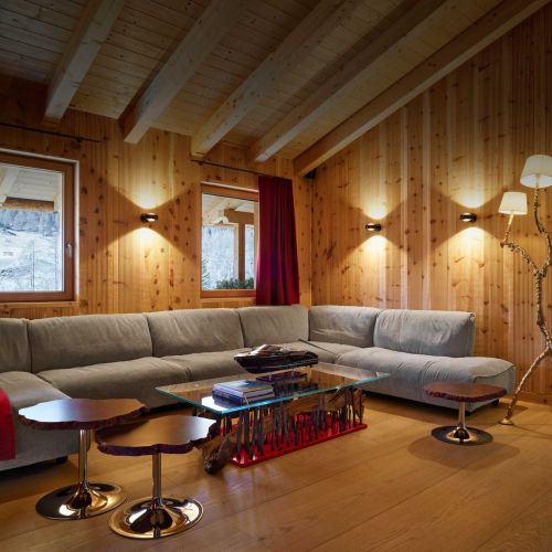   Grande Soffice  and  Cicladi . The sofa by Francesco Binfaré in angular composition inside the living room of the chalet serge together with the tables and the Jacopo Foggini lamp. 